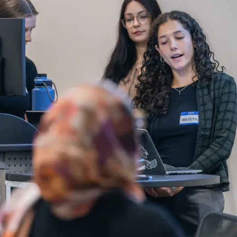 A group of students gives a slideshow presentation